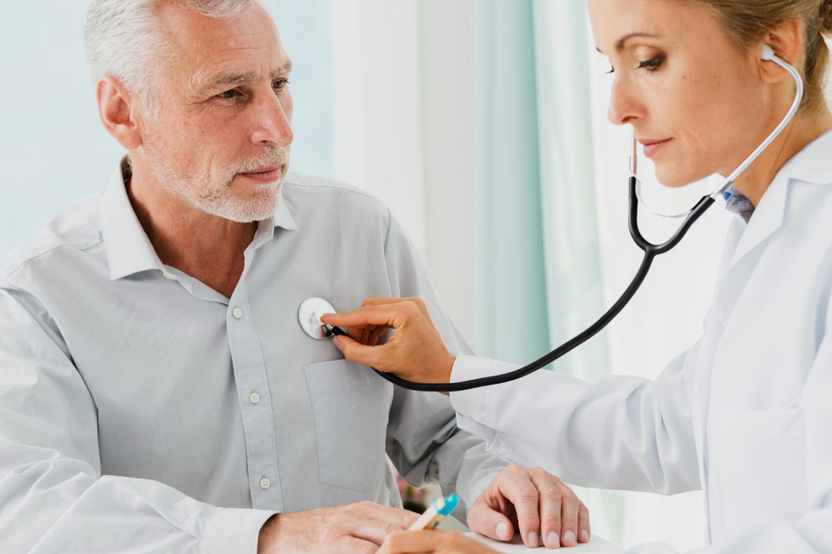 Physician listening to a patient during a visit